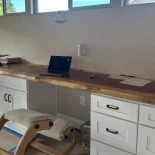 18 foot redwood desktop has been installed in a home office