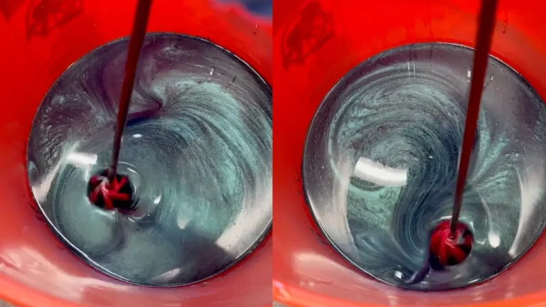 a close up of a bucket containing resin being adjusted to the desired color