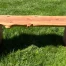 Redwood bench sitting in the grass