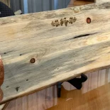pine charcuterie board with a laser etching of a grapevine