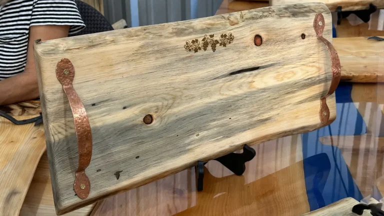 pine charcuterie board with a laser etching of a grapevine